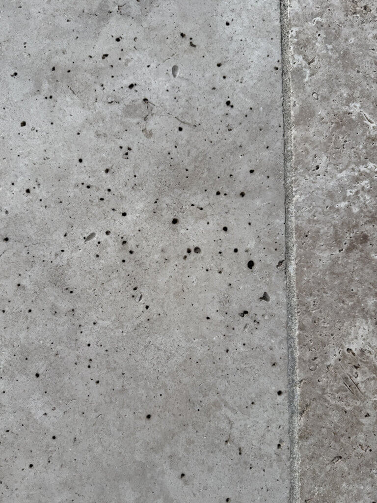 Close-up of natural travertine surface showing small pits and texture