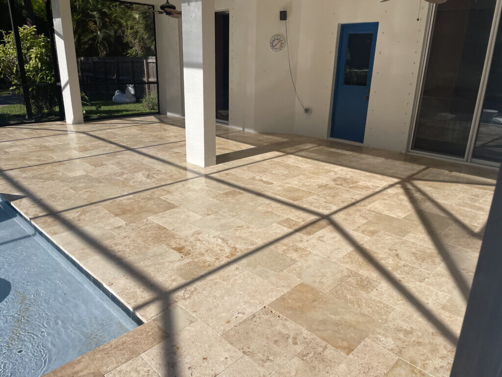 Outdoor travertine patio cleaned and sealed for natural color and traction