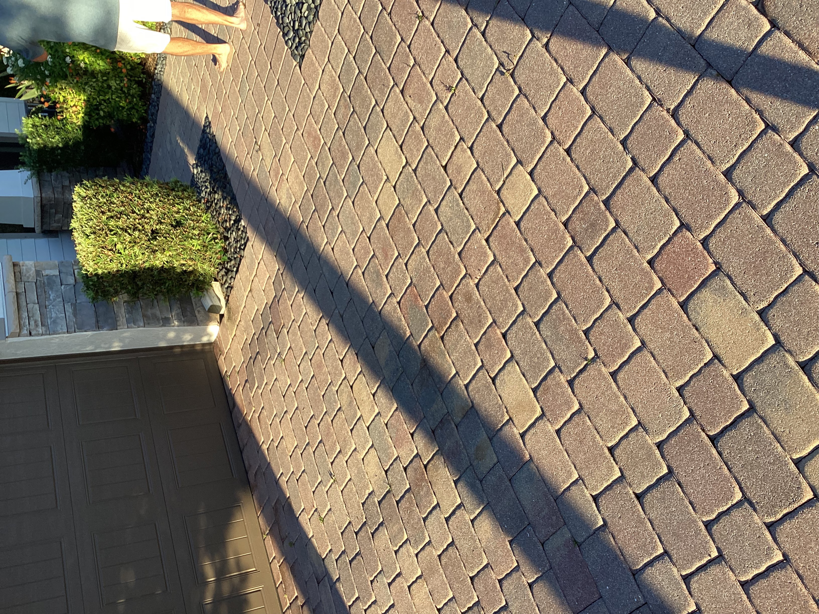 Before photo showing tire ruts in paver driveway in Greyhawk Naples FL