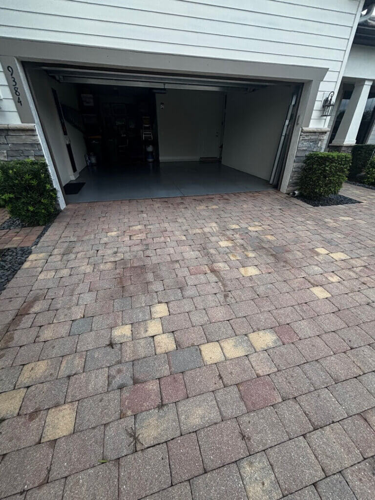 Paver driveway in need of repair and restoration in Greyhawk Naples FL