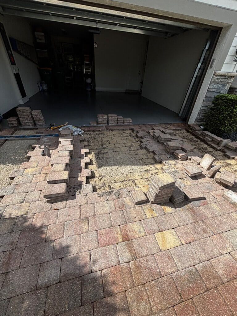 Perfect Paver Co. team restoring Naples paver driveway from tire ruts