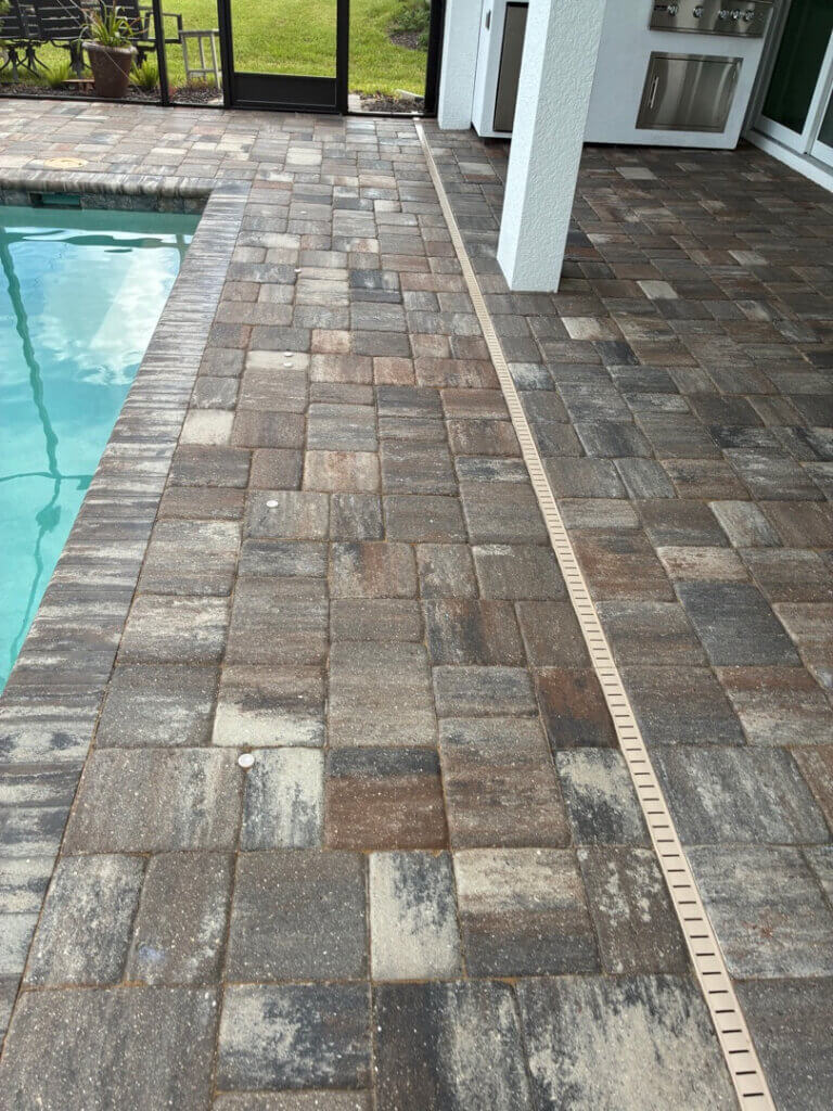 Paver pool deck and lanai after photo right after it was steam cleaned and sealed and polymeric sand was installed in Englewood FL