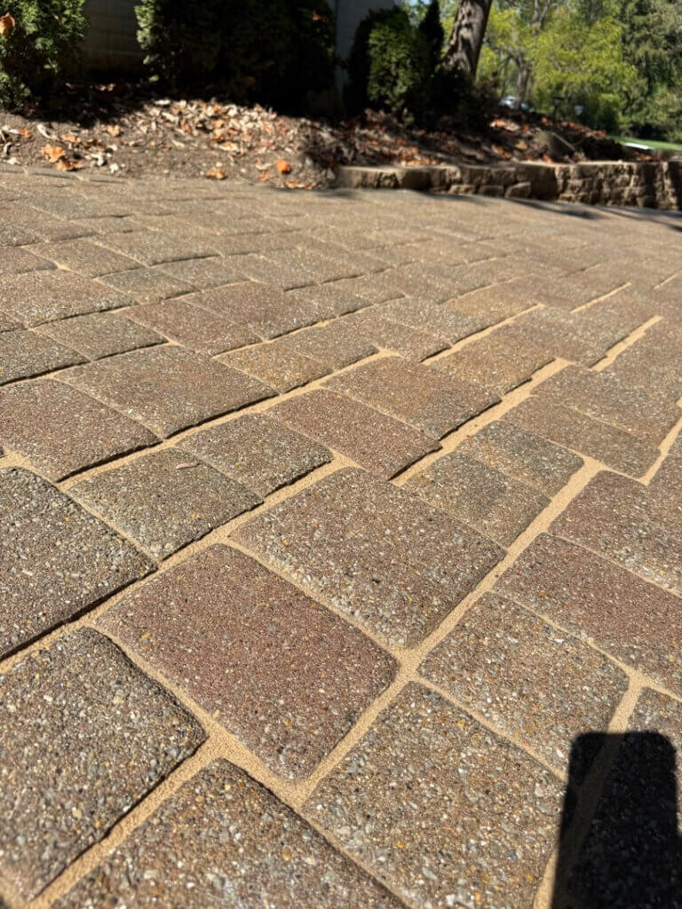 Polymeric sand installation on paver patio in Amberley Village Ohio by Perfect Paver Co
