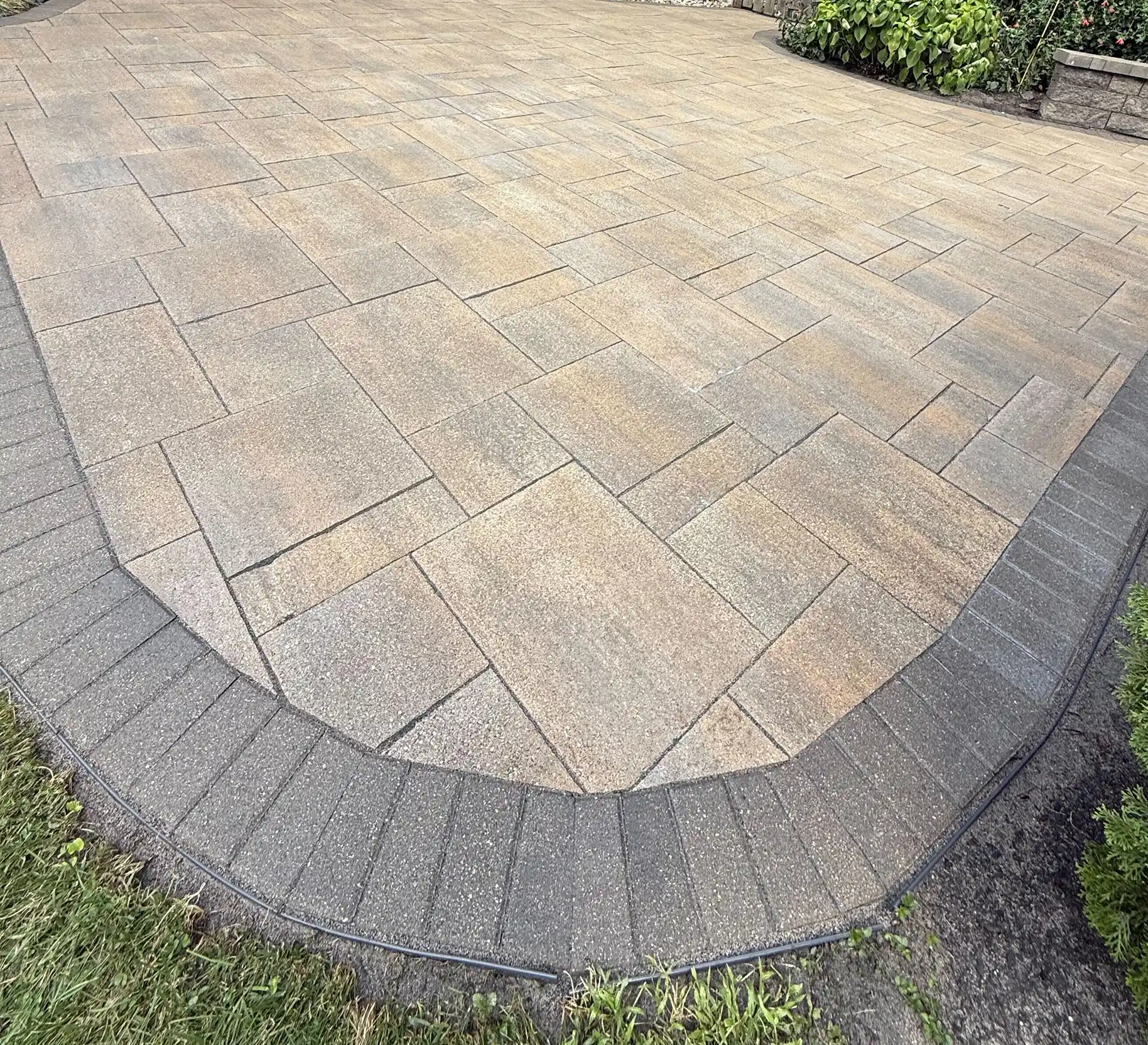 Paver surface showcasing a well-maintained patio with large interlocking stones and contrasting border, highlighting the benefits of paver restoration services by Perfect Paver Co in Ohio.