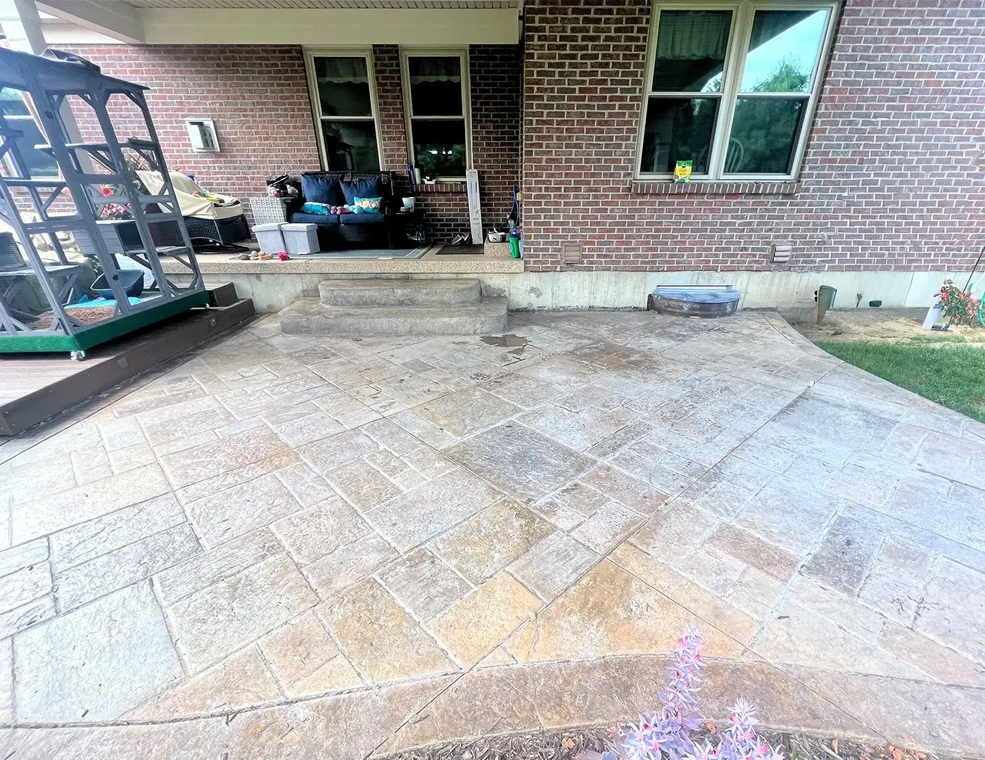 Stamped concrete patio surface showing preparation for sealing, highlighting texture and color enhancement for durability and aesthetic appeal.
