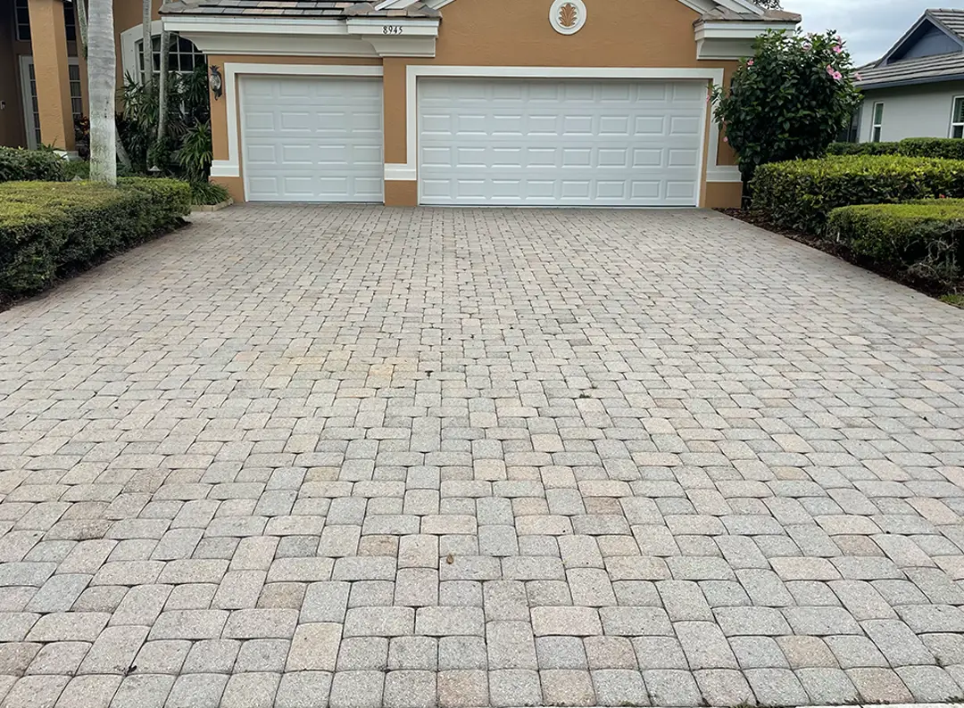 Paver driveway featuring a natural stone appearance, showcasing varying shades and textures, highlighting the need for color restoration through professional tinting services by Perfect Paver Co.